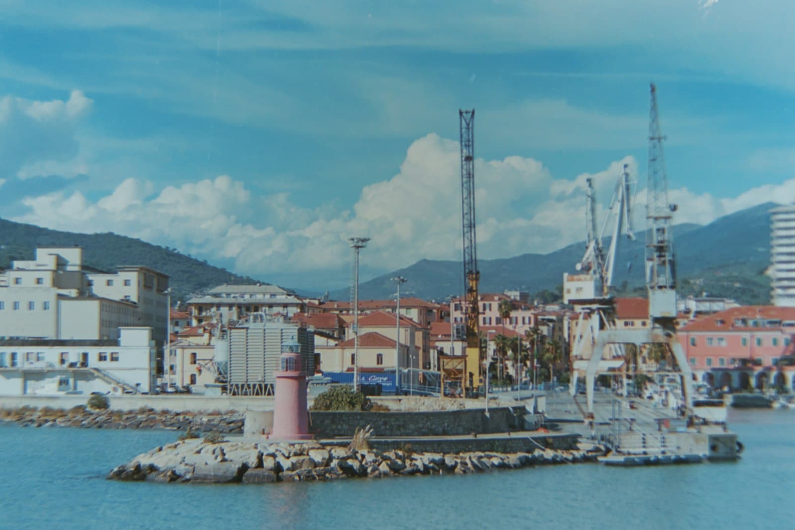 Imperia — a picture of a harbor with a lighthouse in the foreground