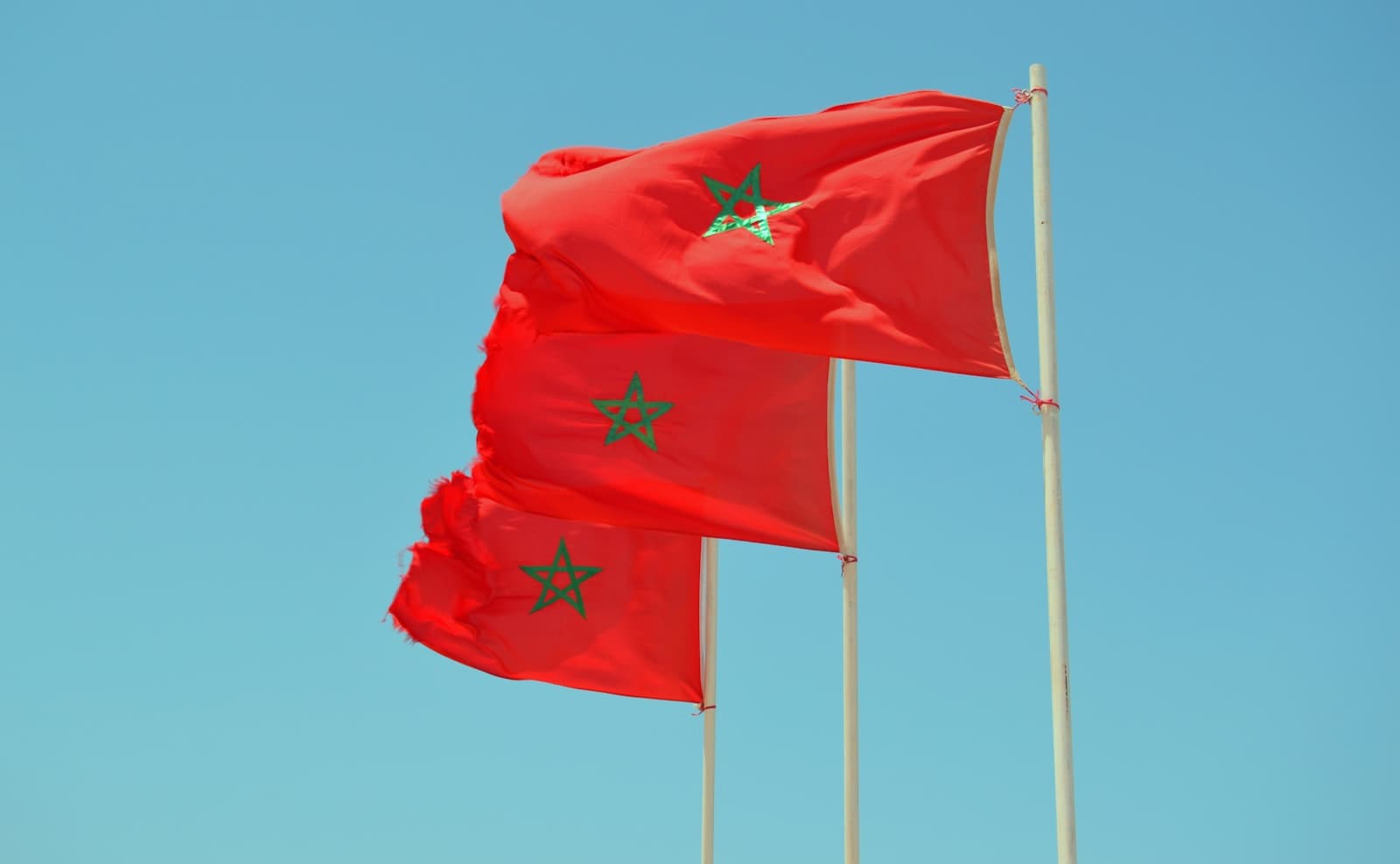 Imsouane — red flag on pole under blue sky during daytime