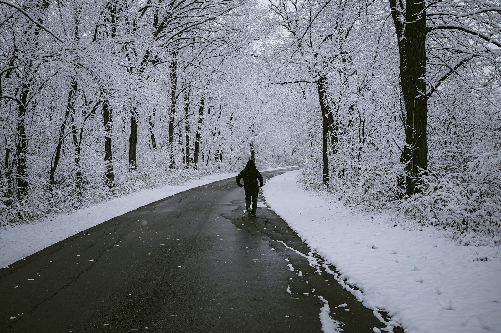 Iowa City — a person walking on a road in the snow