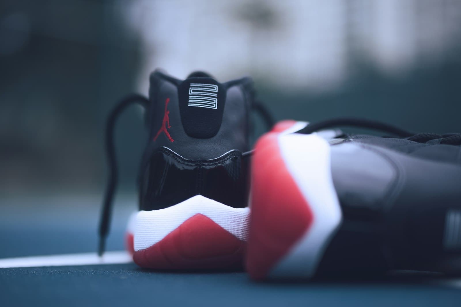 Irbid — shallow focus photo of pair of bred Air Jordan 11's