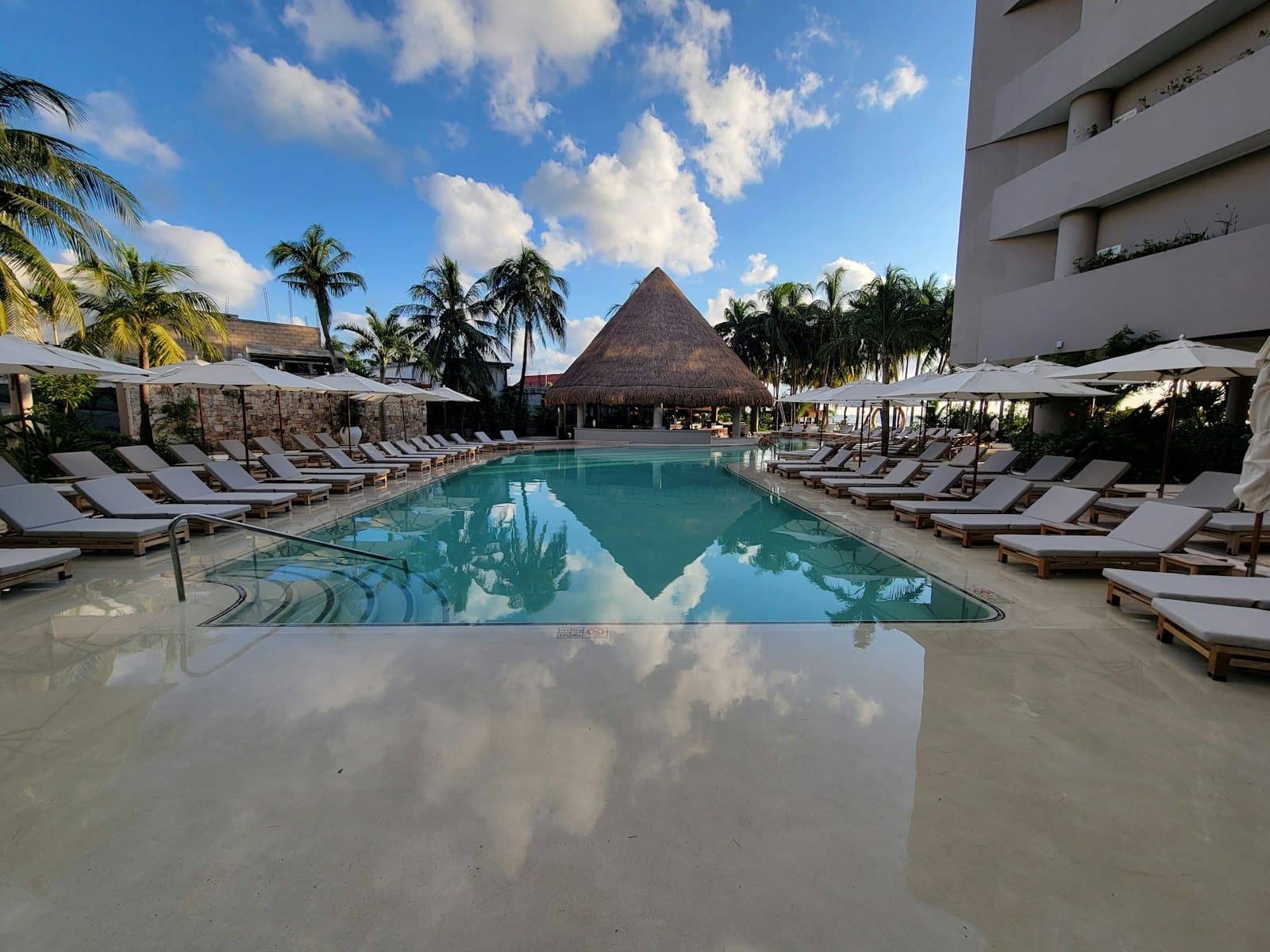 Isla Mujeres — A large swimming pool with lounge chairs and umbrellas