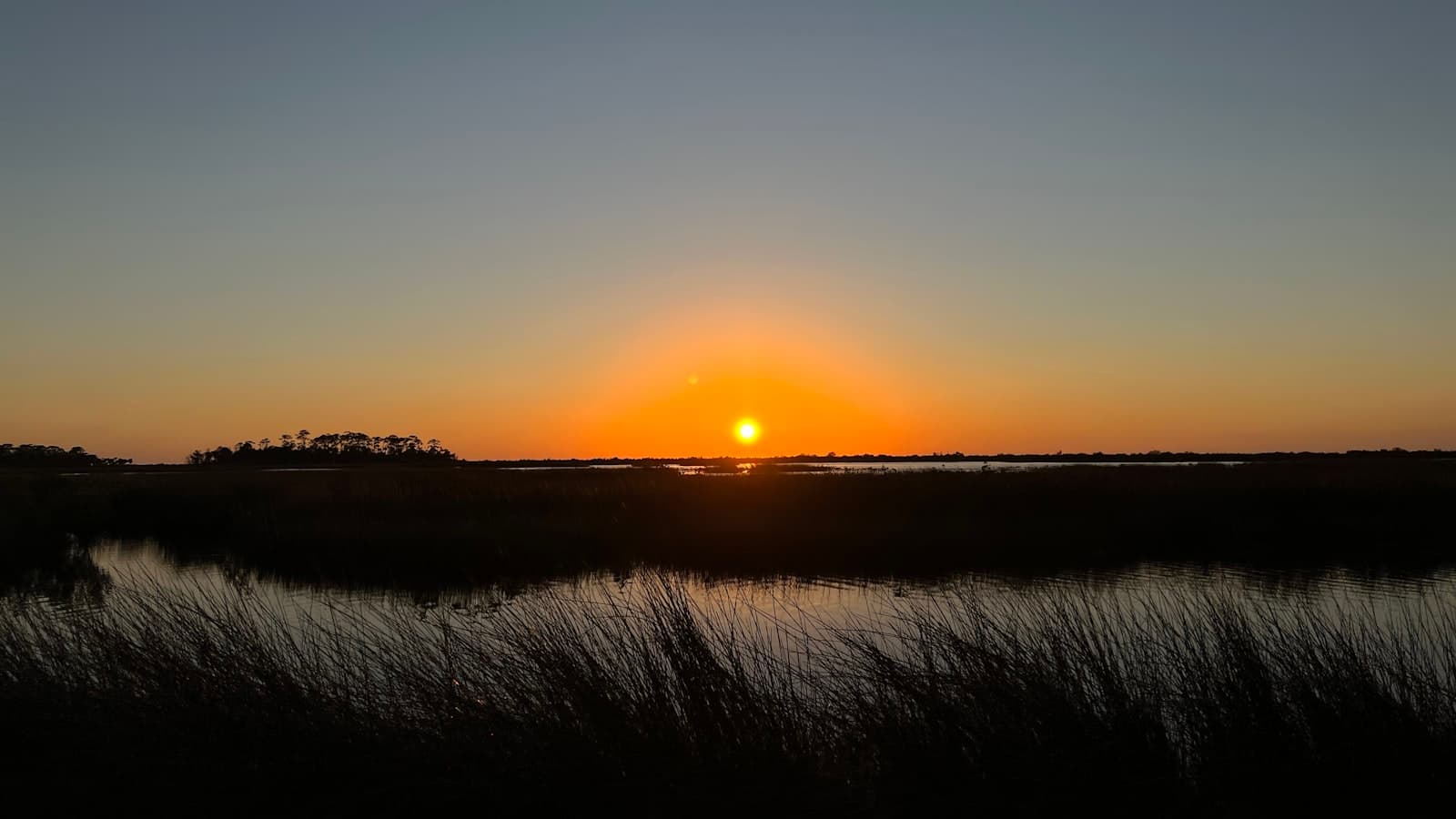 Jacksonville — the sun is setting over a marshy area