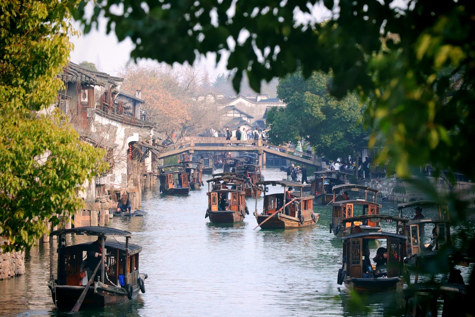 Jiaxing (Nanhu) — a river filled with lots of boats floating on top of it