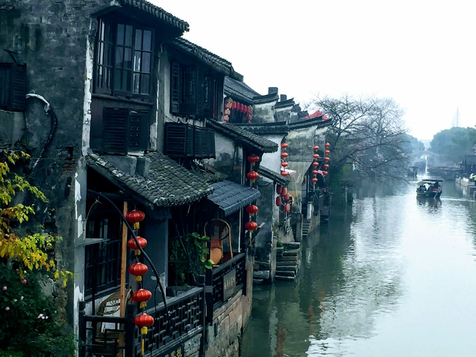 Jiaxing (Nanhu) — black and white wooden houses beside river during daytime