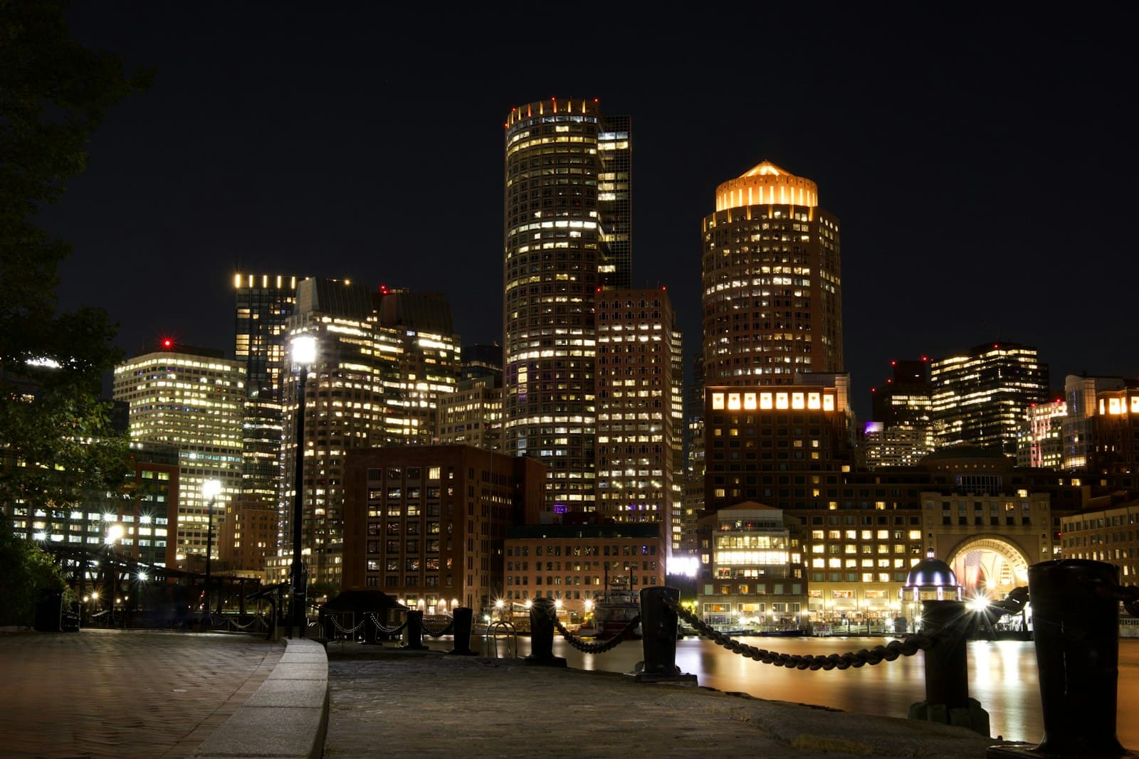 Joseph — City skyline illuminated at night with glowing windows.