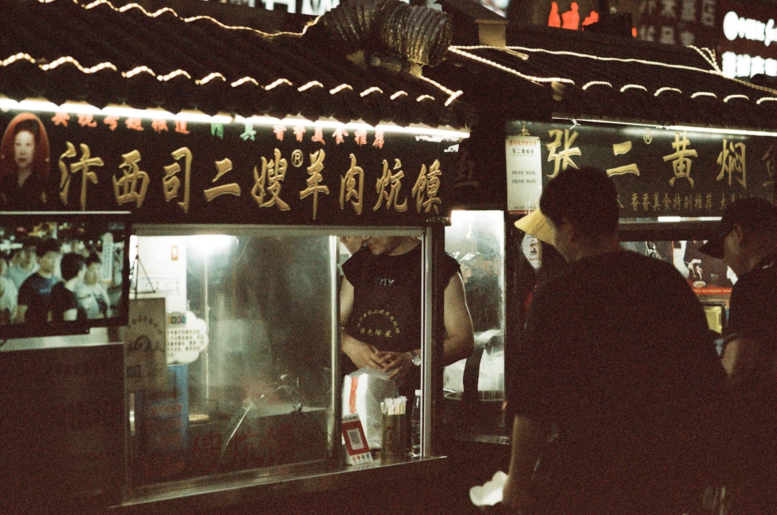 Kaifeng — a group of people standing outside of a building at night
