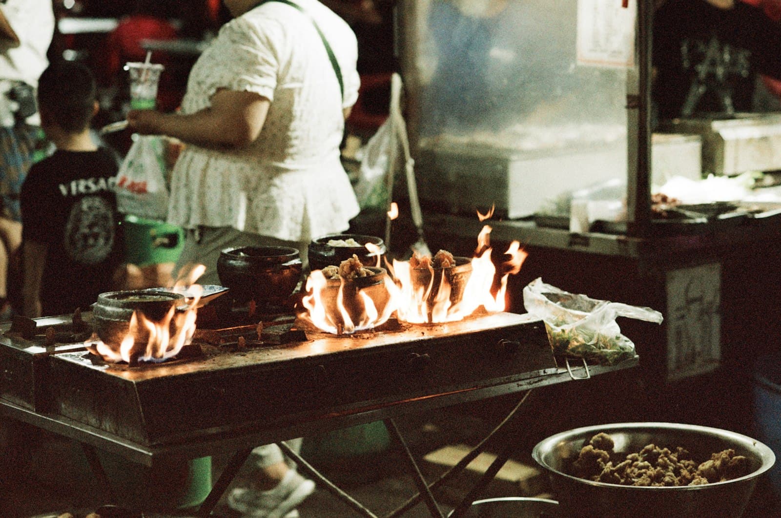 Kaifeng — a person cooking food on a grill in a kitchen