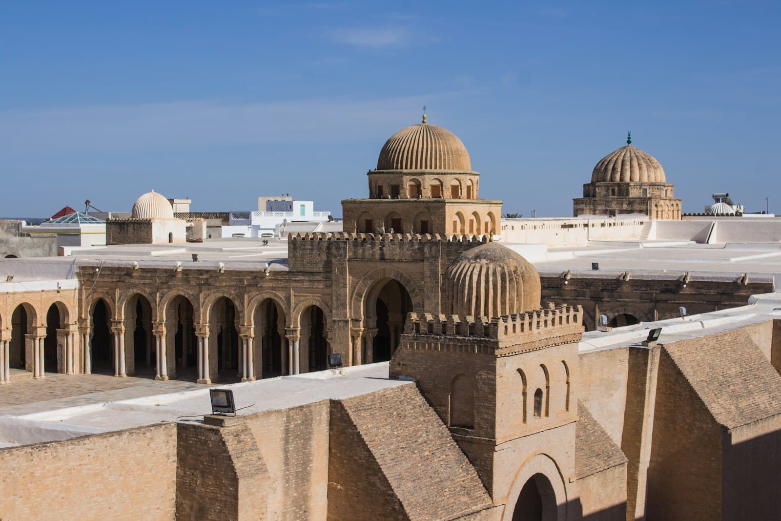 Kairouan — a large building with domed roofs with Kairouan in the background