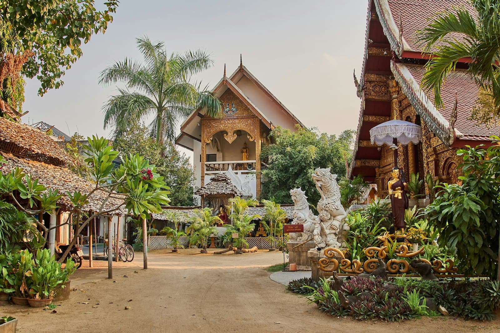 Kamphaeng Phet — brown and white concrete house surrounded by green trees during daytime