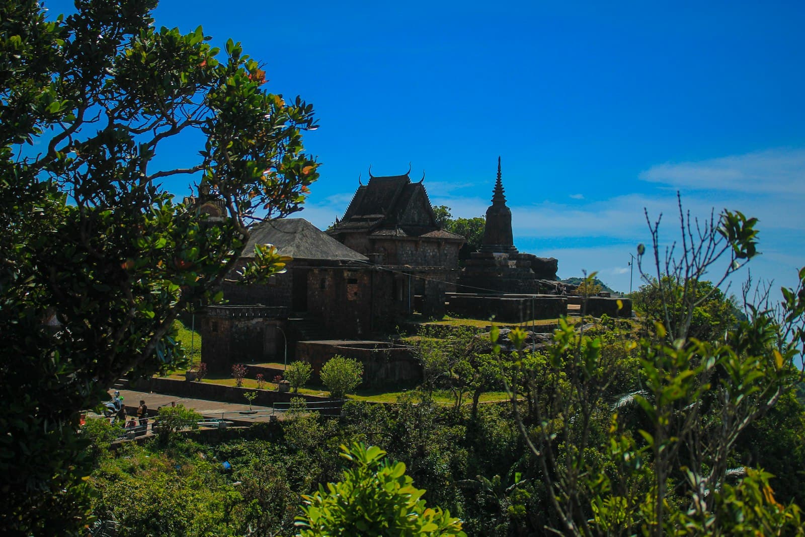 Kampot — a large building sitting on top of a lush green hillside