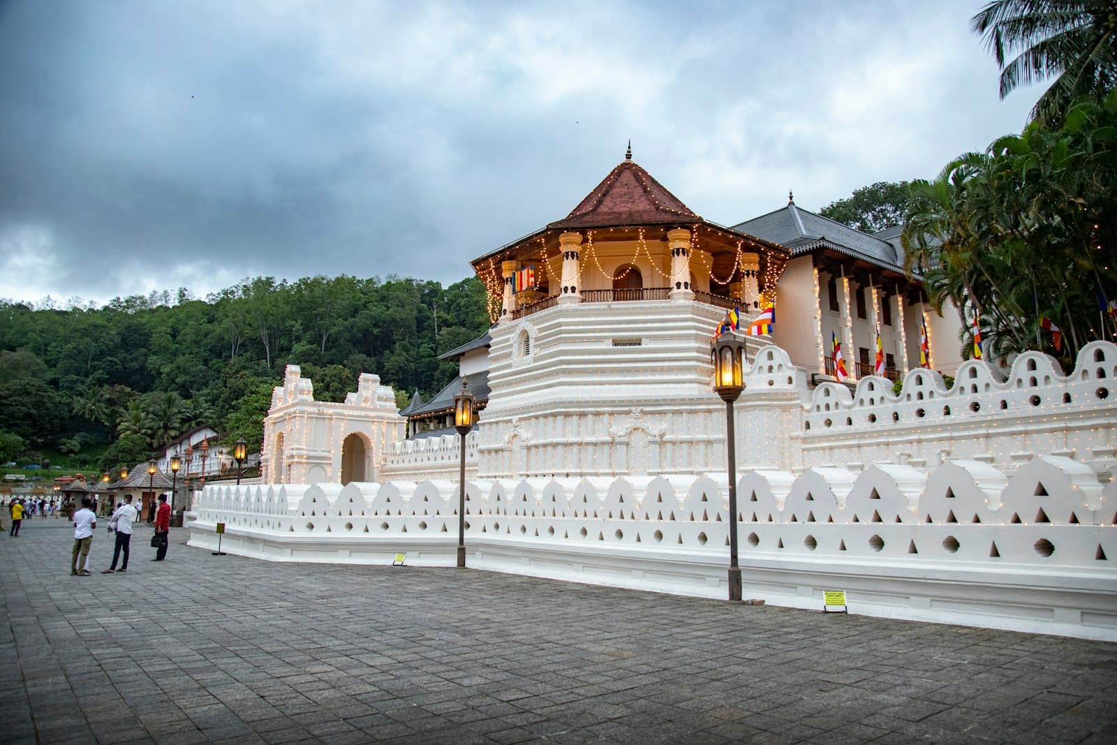 Kandy — a white building with a gold roof with Temple of the Tooth in the background