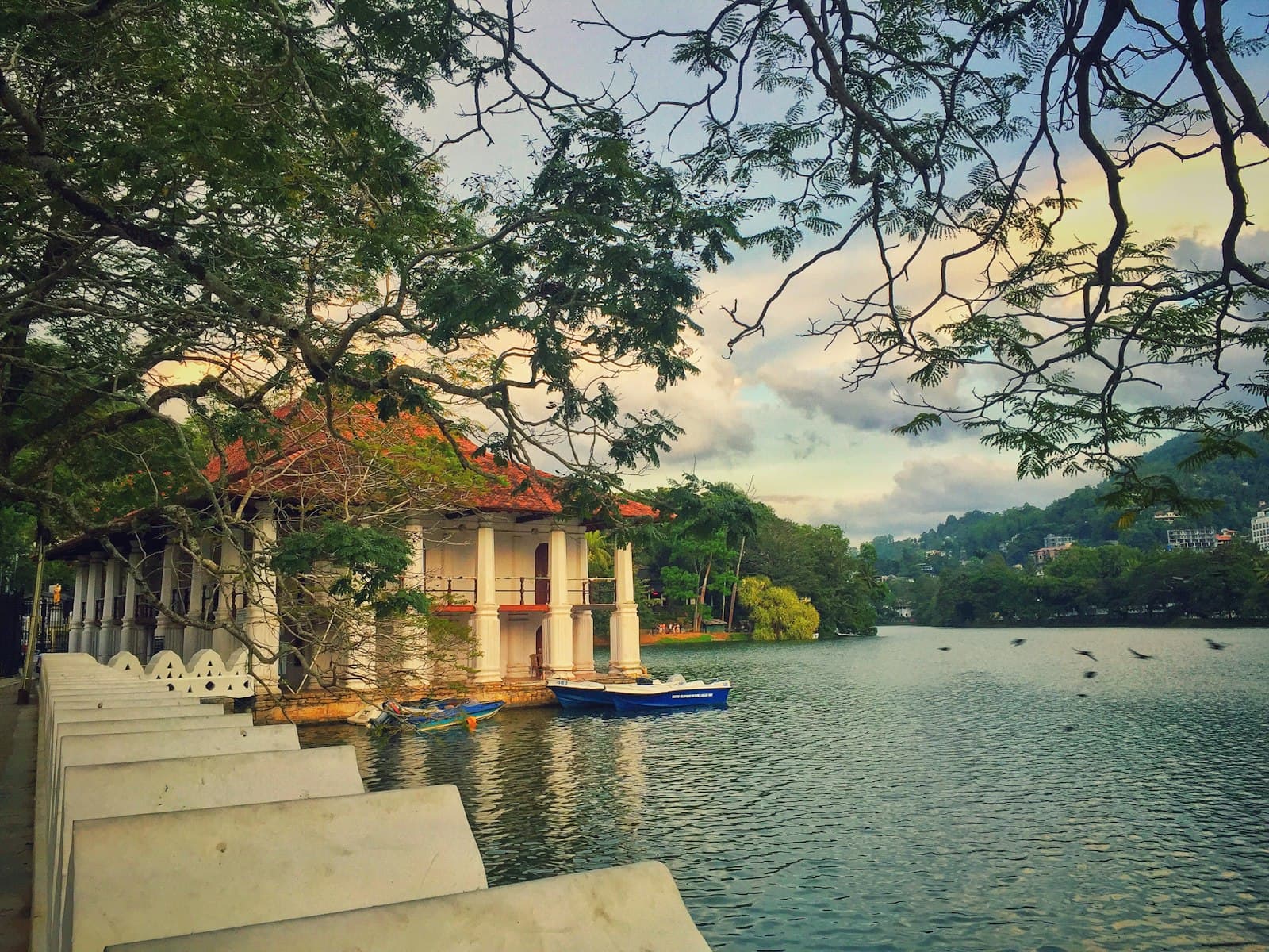 Kandy — white and brown concrete building near body of water during daytime