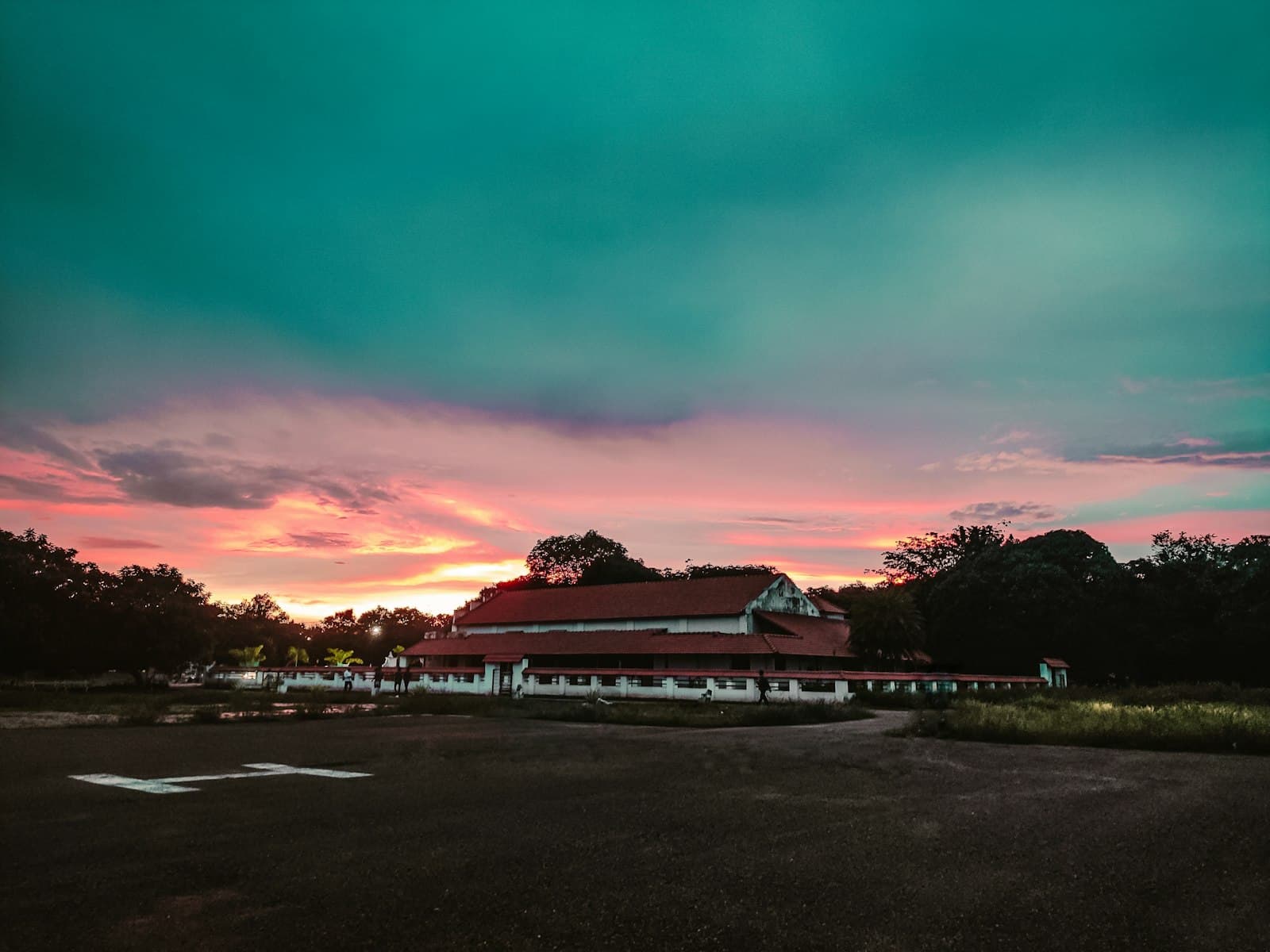 Karaikudi — a building with a sunset in the background