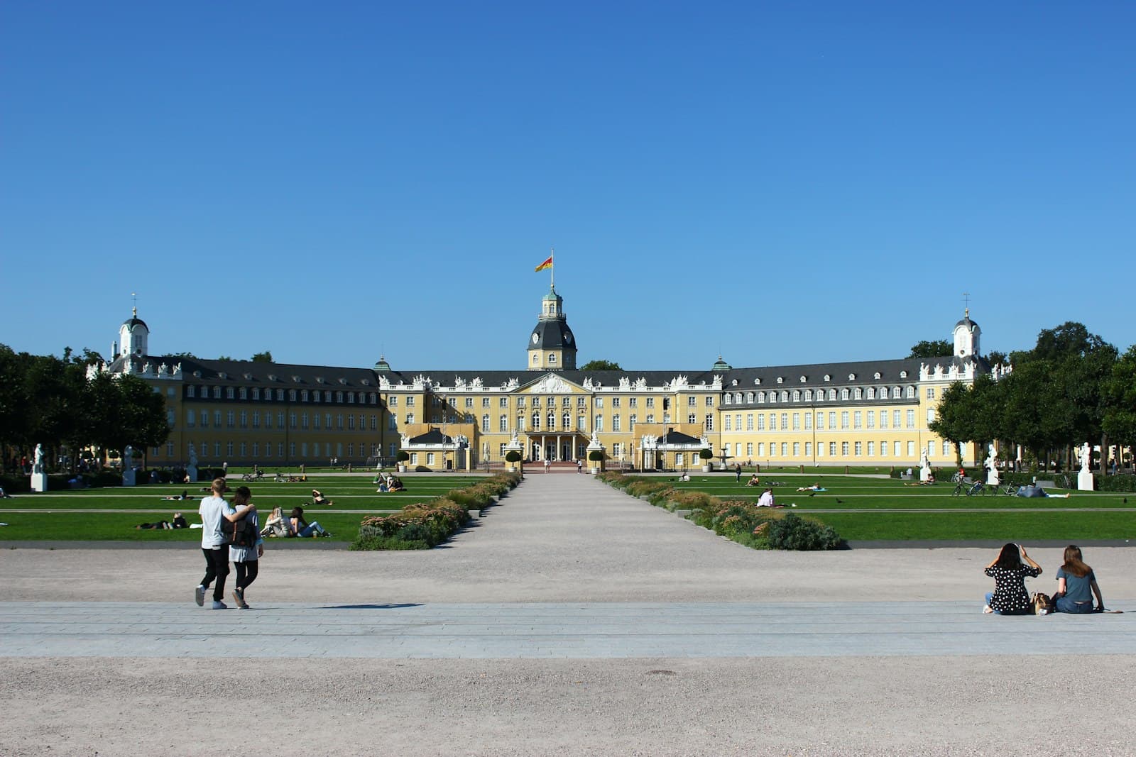 Karlsruhe — a group of people sitting on the ground in front of a building