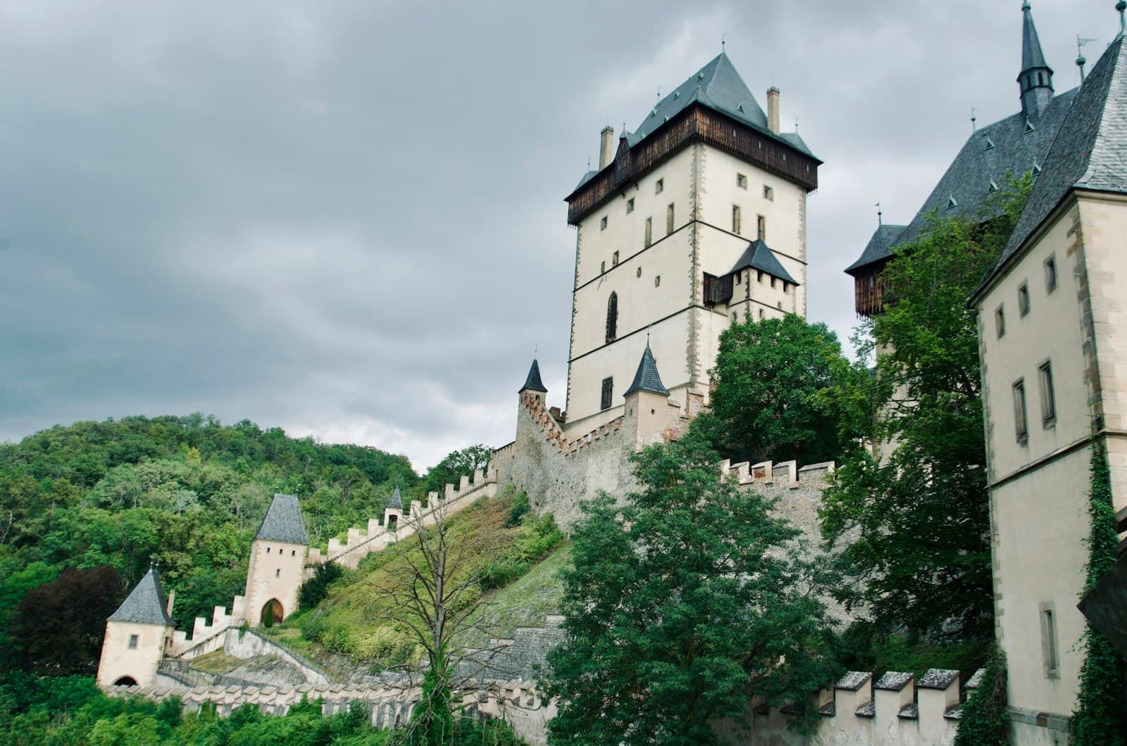 Karlštejn — A castle on a hill surrounded by trees