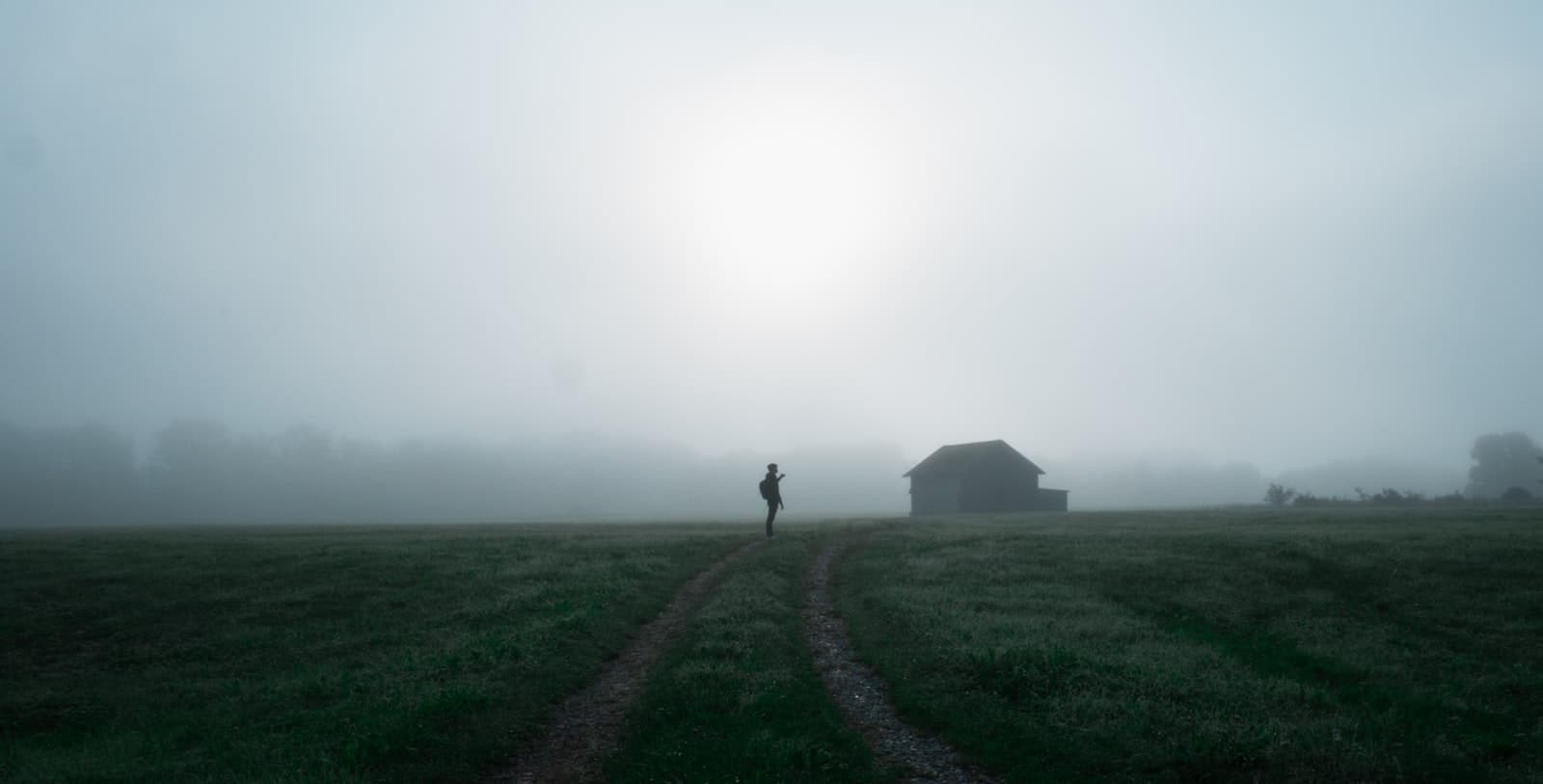 Kaufbeuren — a person walking on a dirt path in a foggy field