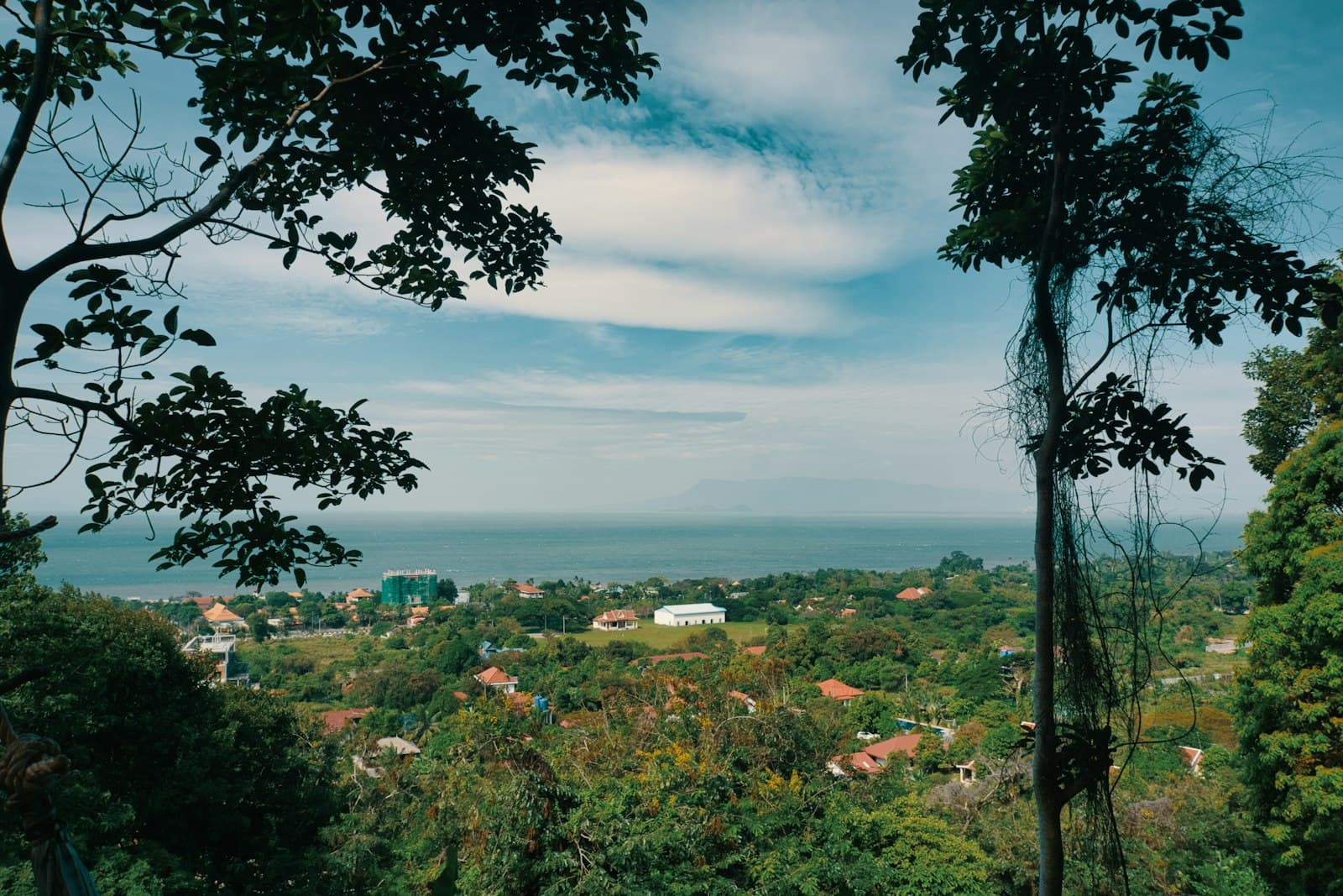 Kep — green trees and houses under blue sky and white clouds during daytime