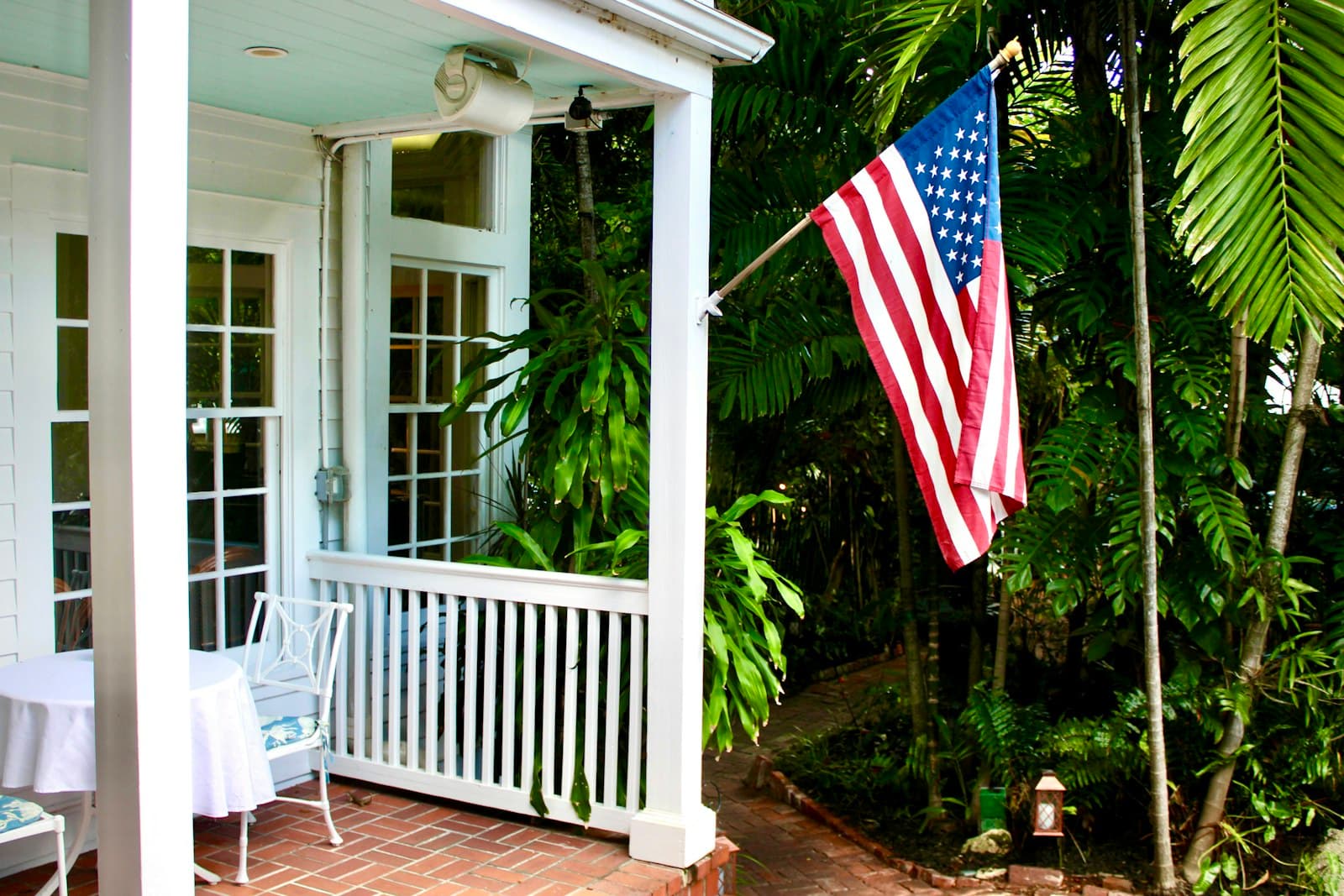 Key West — American flag on a porch with lush greenery