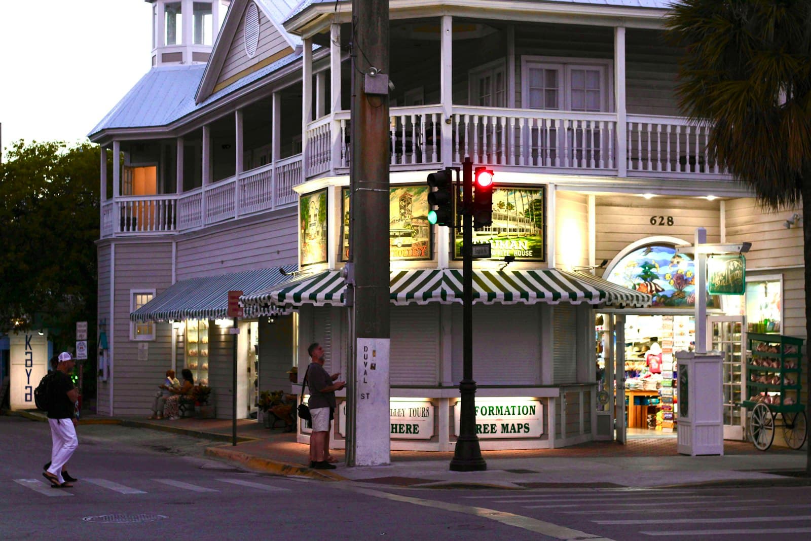 Key West — Corner building with shops and people at dusk