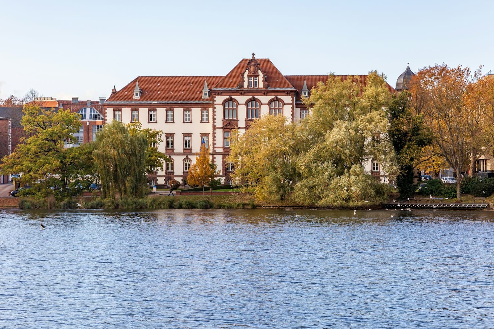 Kiel — a large building sitting on the side of a lake