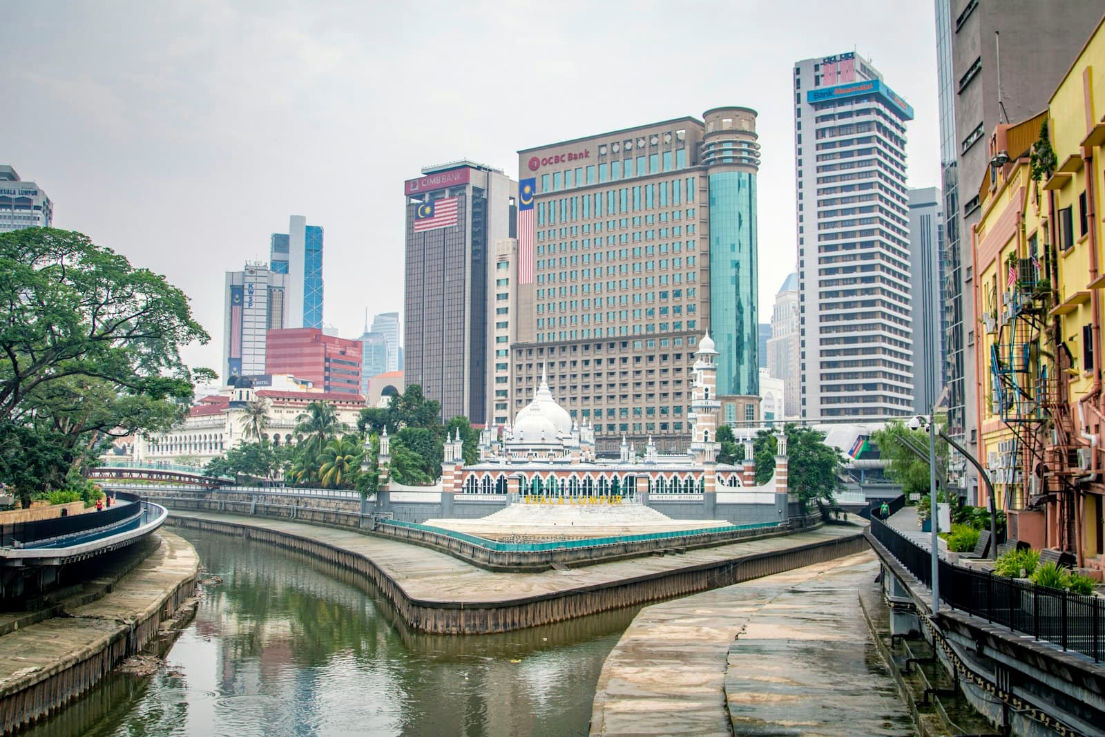 Klang — white and blue boat on river near city buildings during daytime