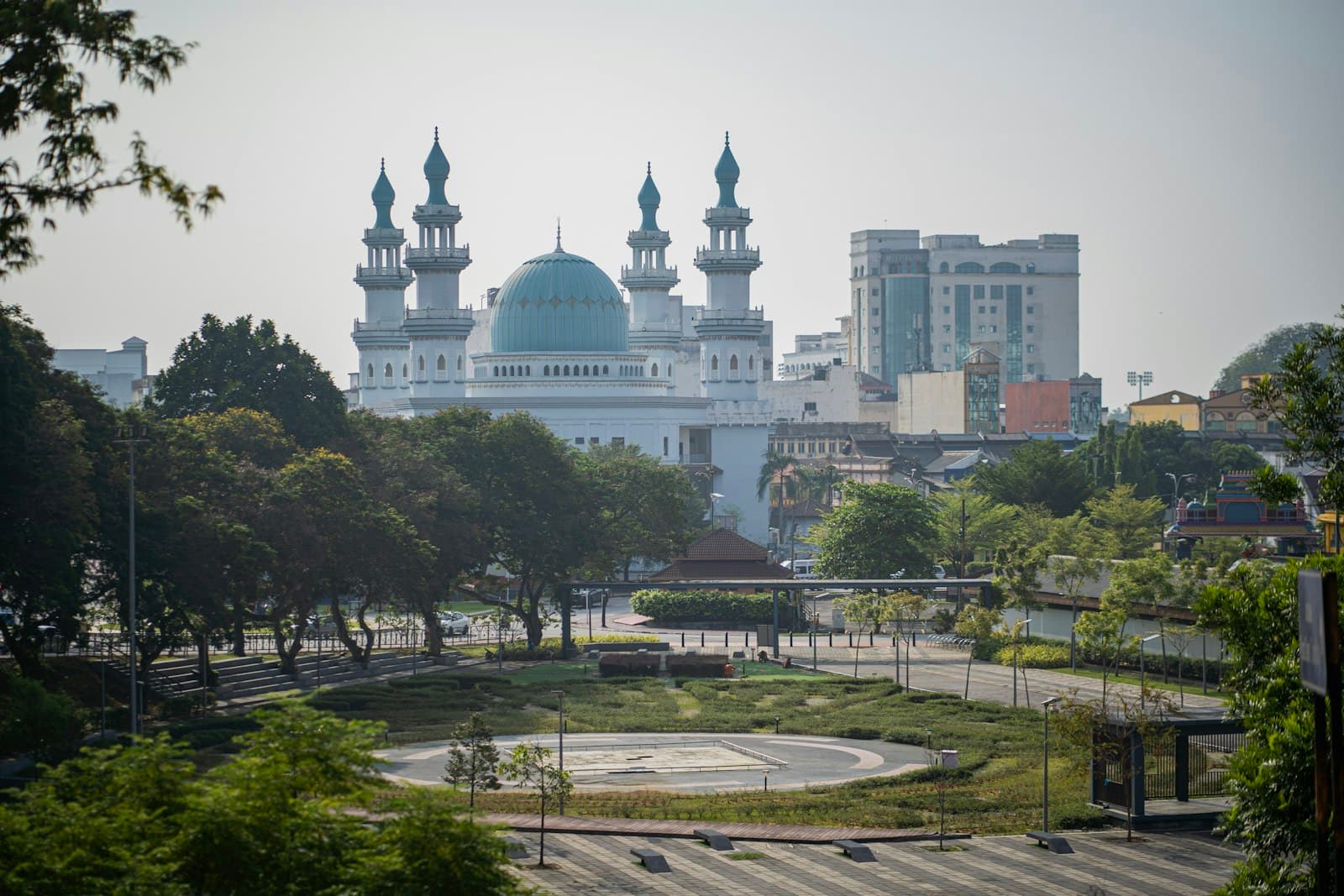 Klang — a large white building with a blue dome in the middle of a park