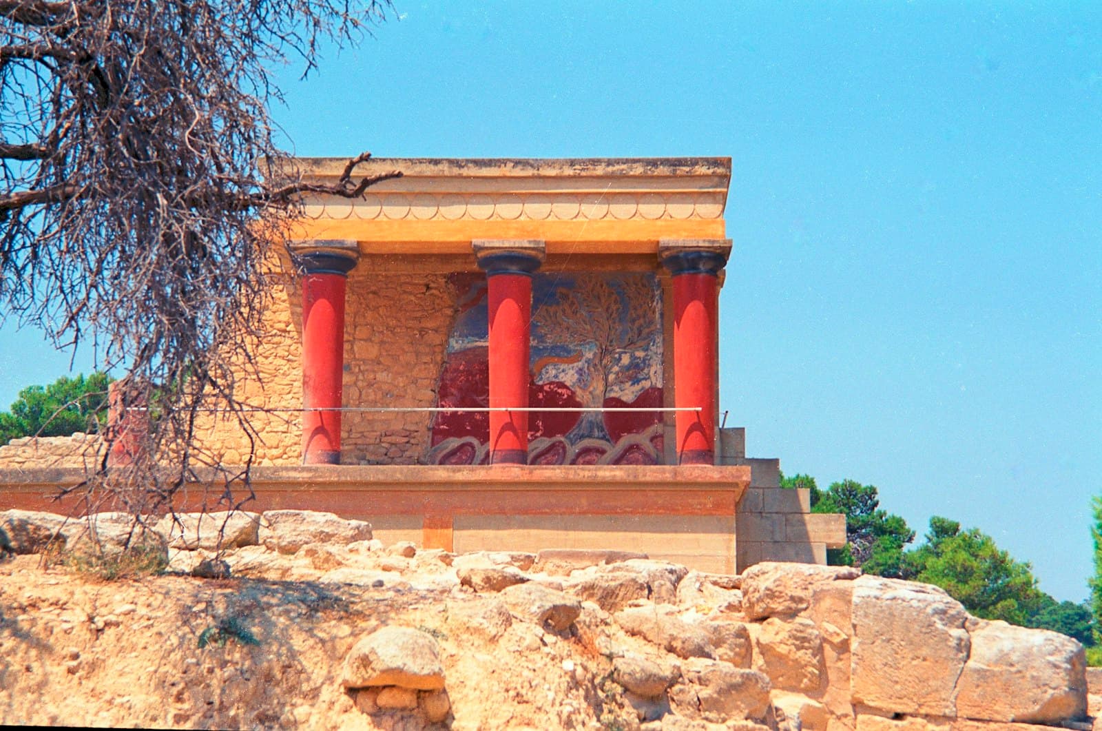 Knossos — Minoan palace ruins with distinctive red columns and blue sky.