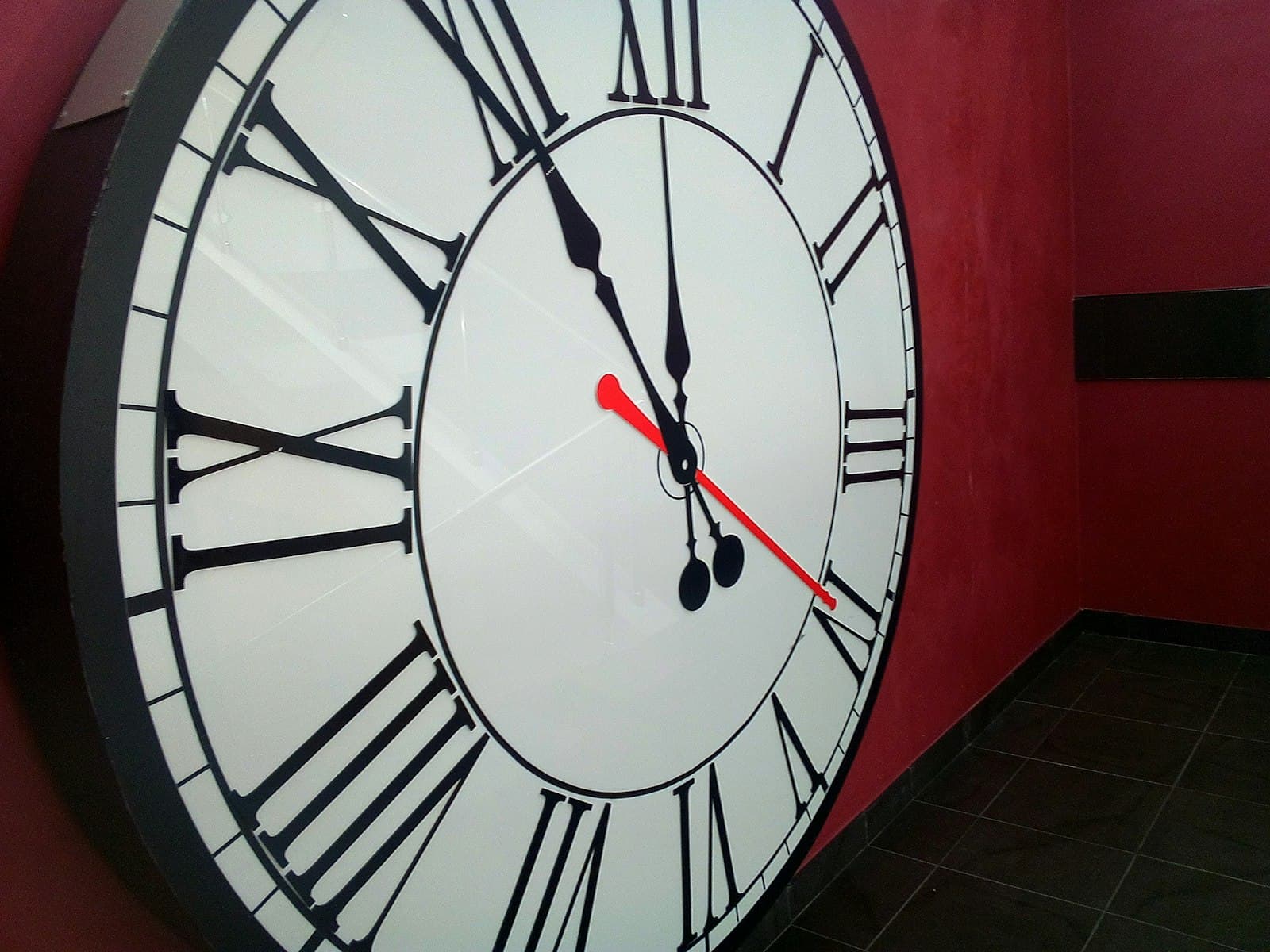 Kursk — a large clock on a red wall in a room