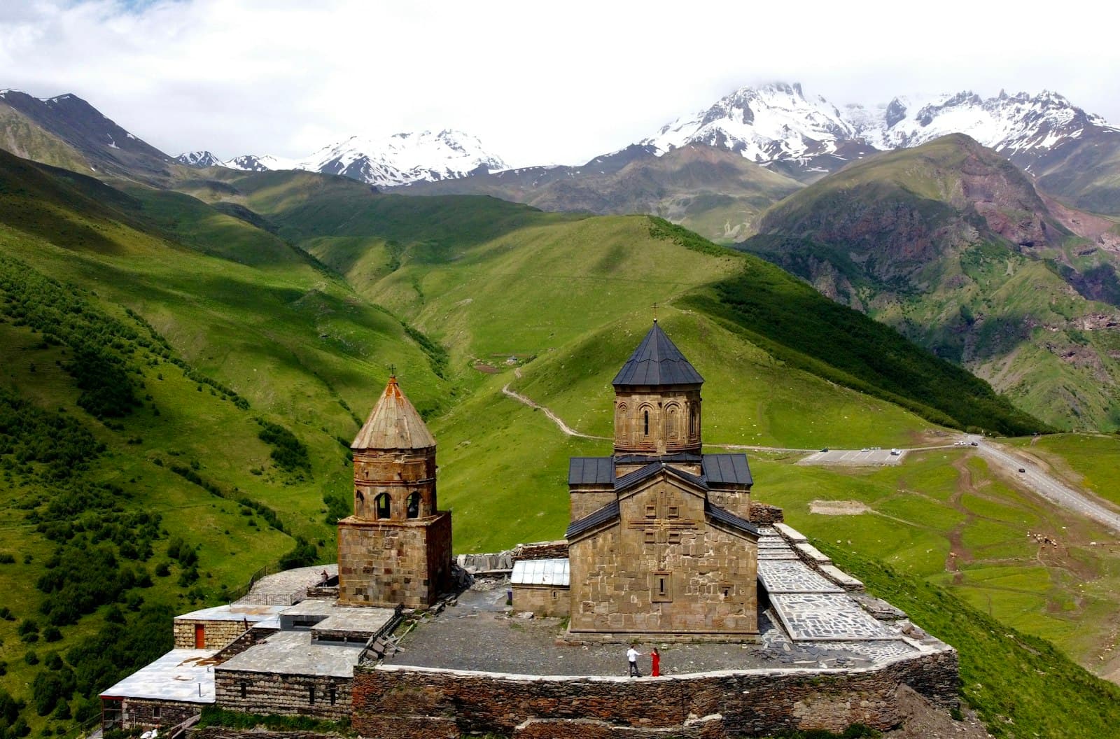 Koutaïssi — brown brick building on green grass field near mountain during daytime