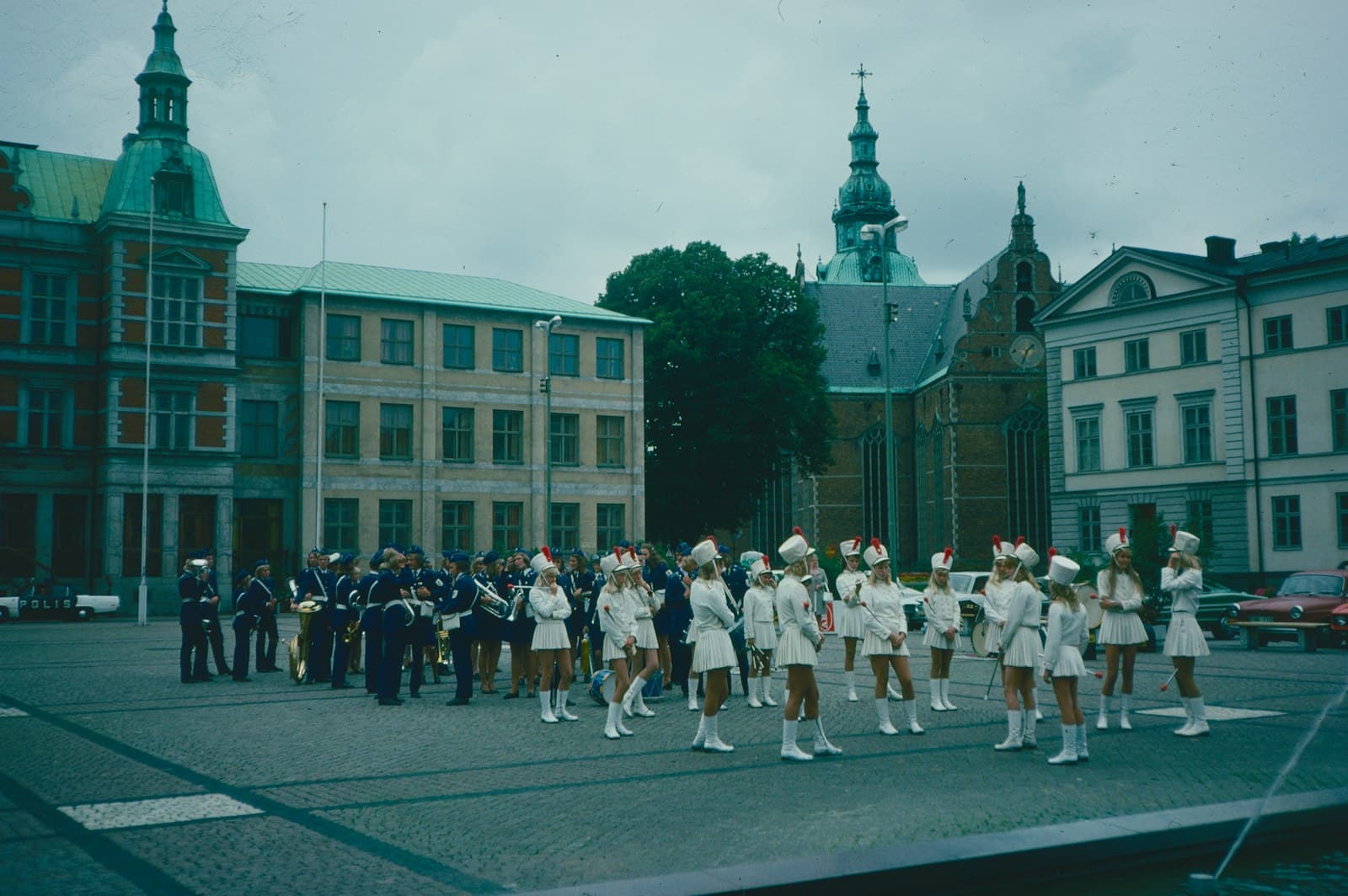 Kristianstad — a group of people in white marching in a parade