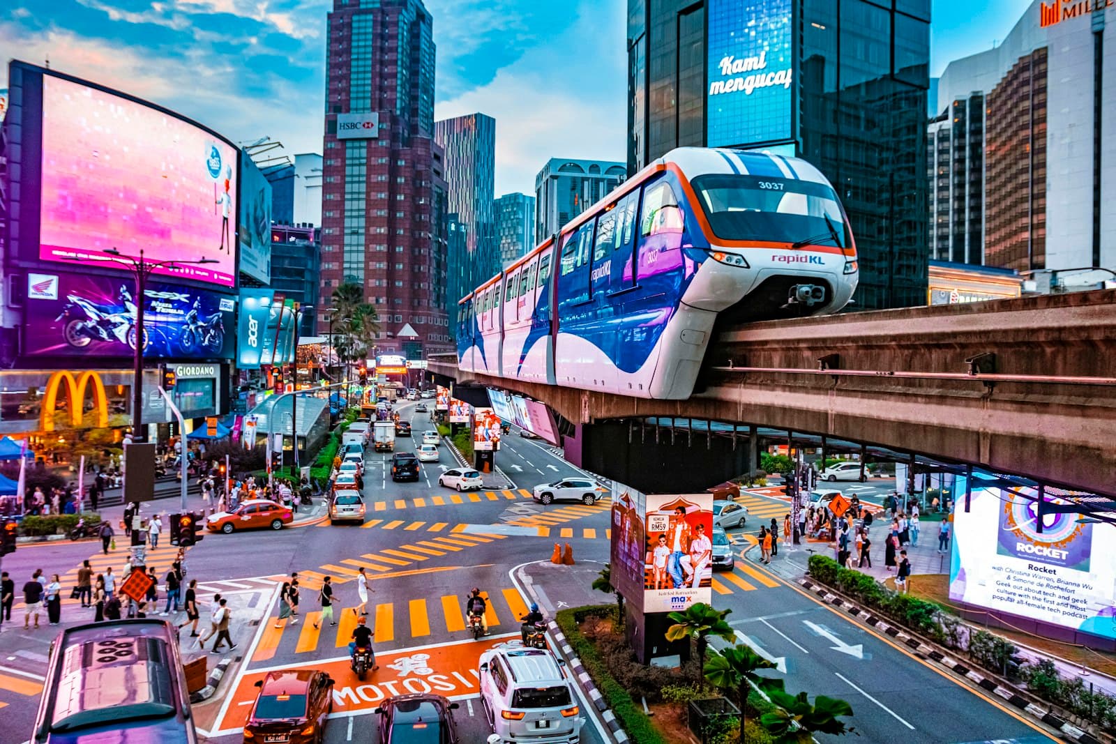 Kuala Lumpur — a city street filled with traffic and tall buildings