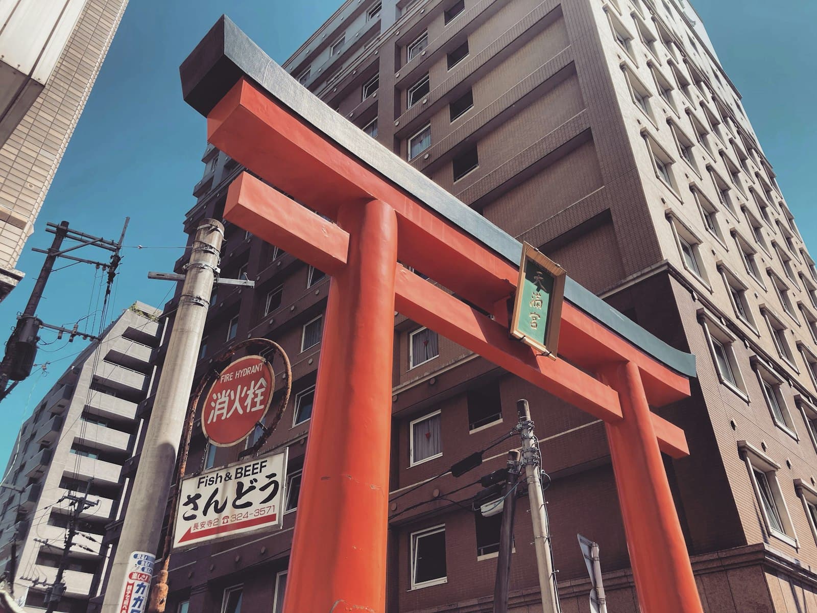 Kumamoto — a tall building with a large red gate in front of it