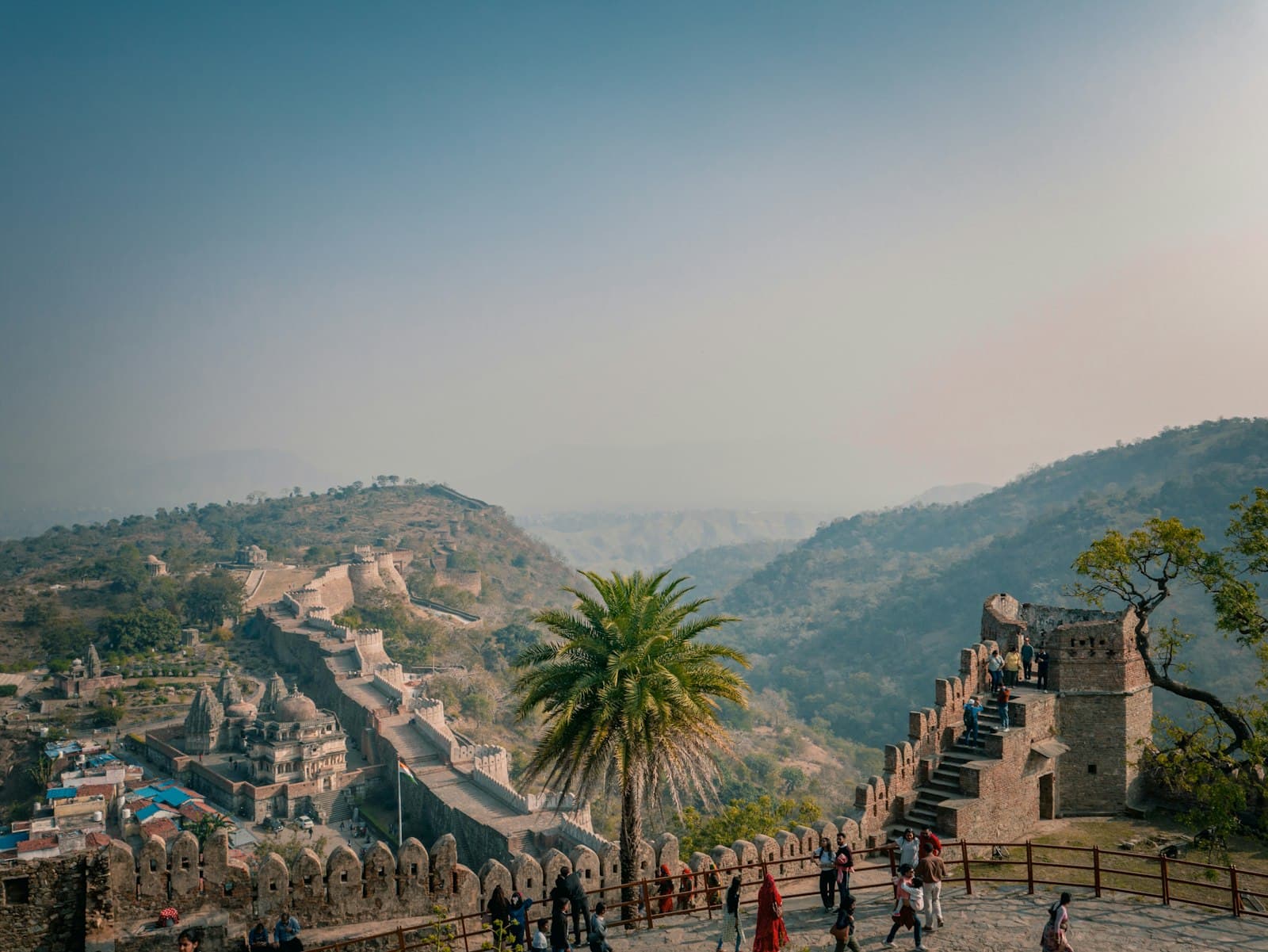 Kumbhalgarh — a group of people standing on top of a stone wall