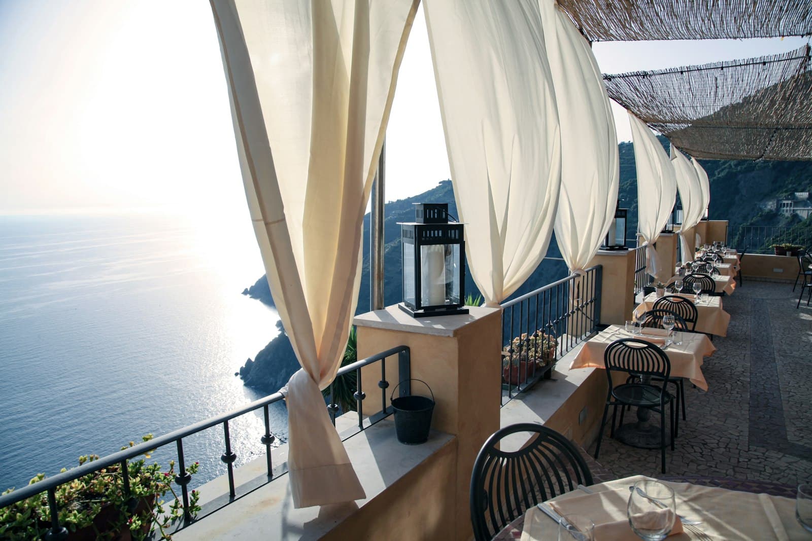 La Spezia — brown wooden table with chairs near window