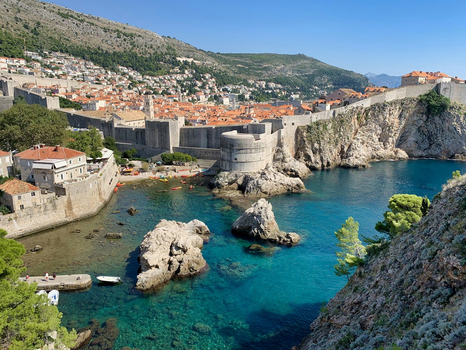 Labin — white and brown concrete building near body of water during daytime