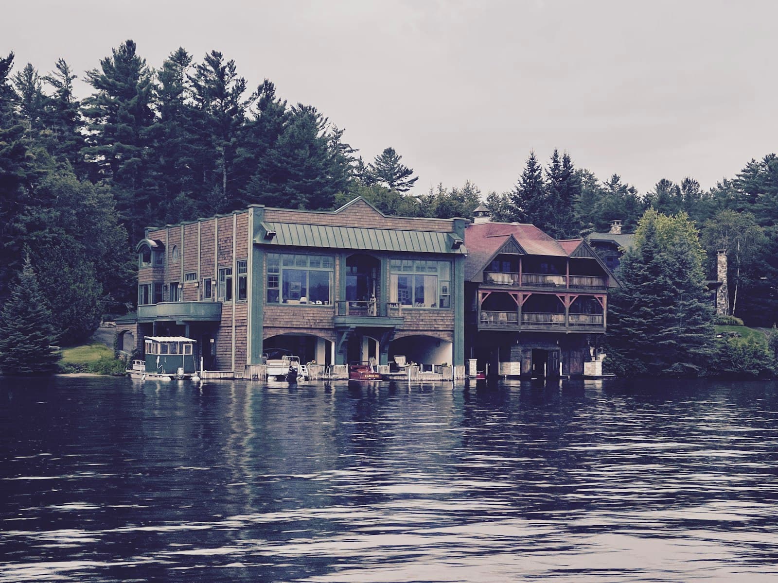 Lake Placid — green and brown wooden house near body of water during daytime