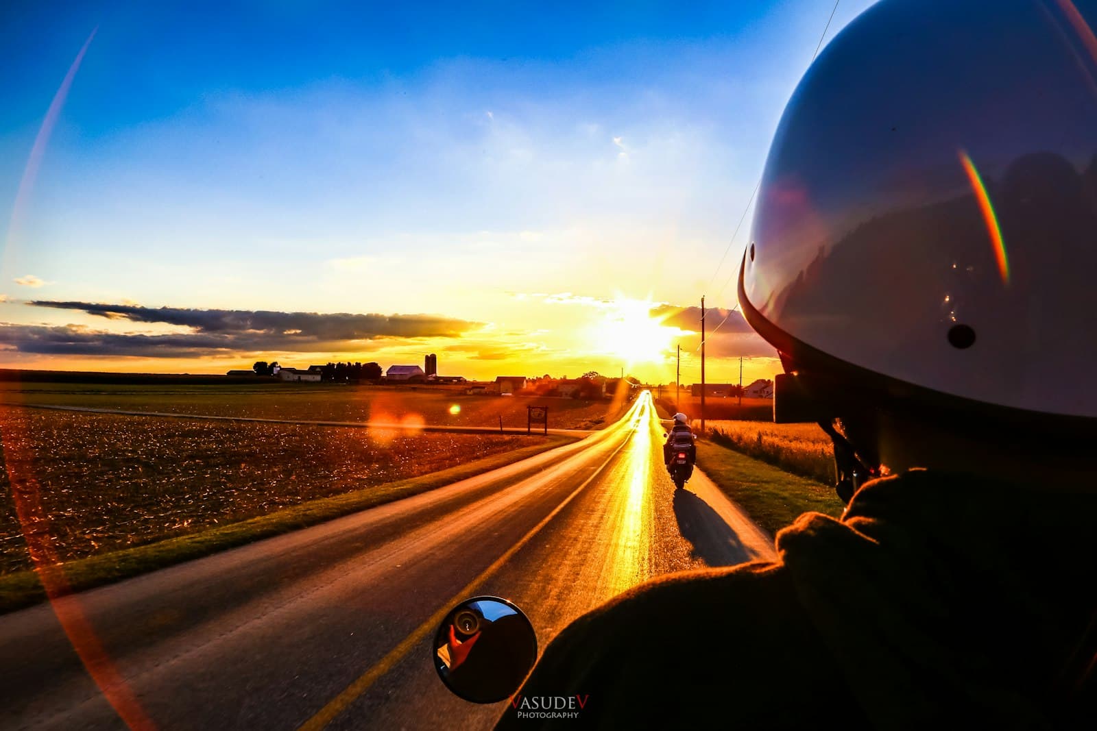 Lancaster — person driving car on road during sunset