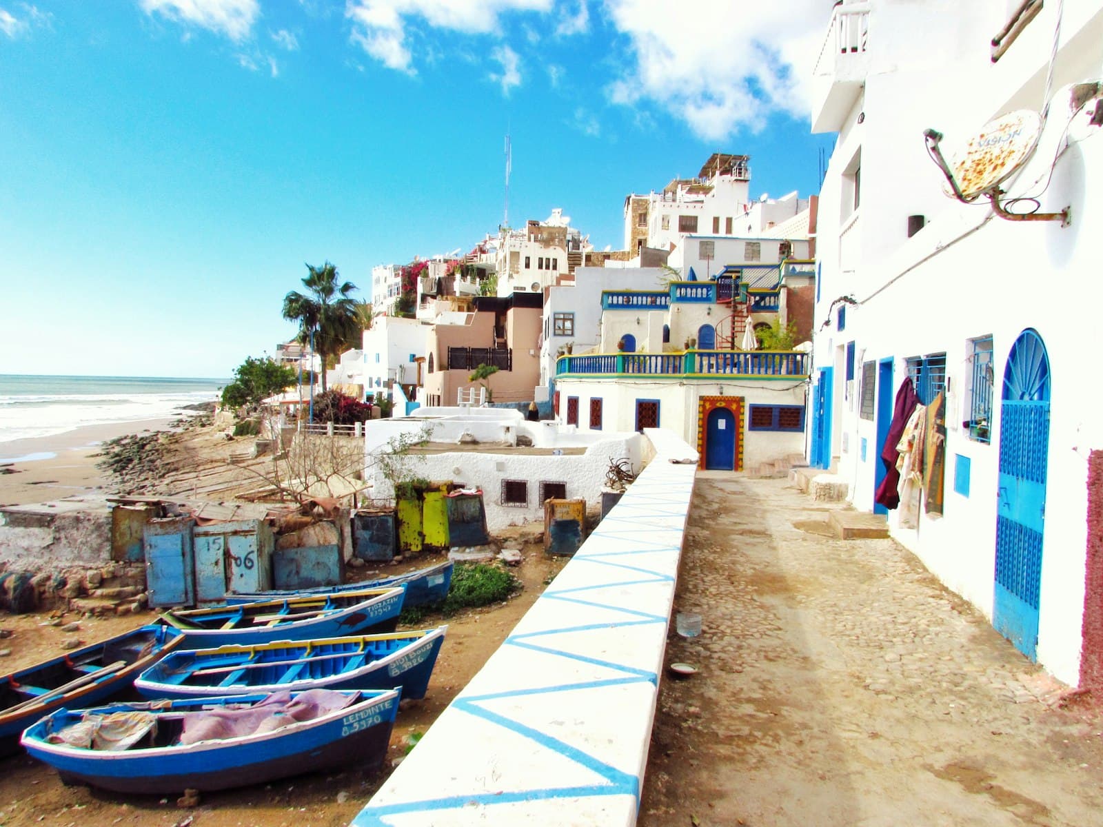 Larache — boatd docked near houses and body of water