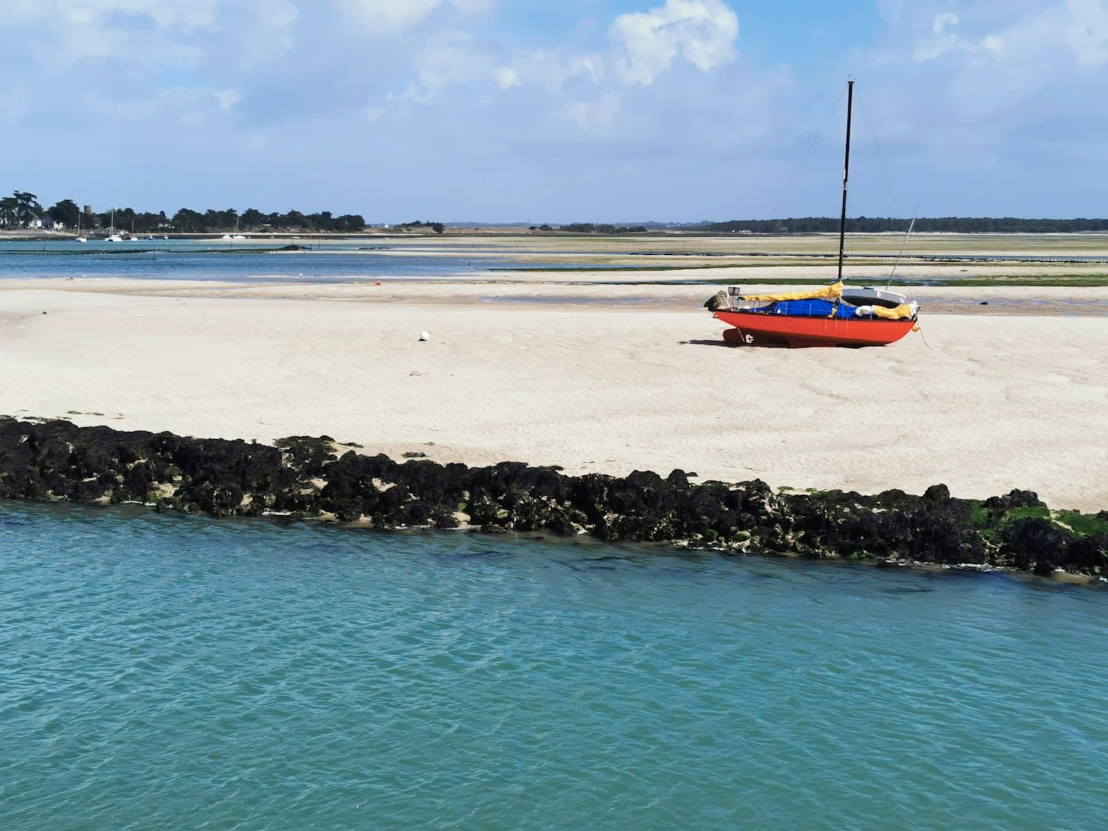 Le Croisic — orange and white boat on sea shore during daytime