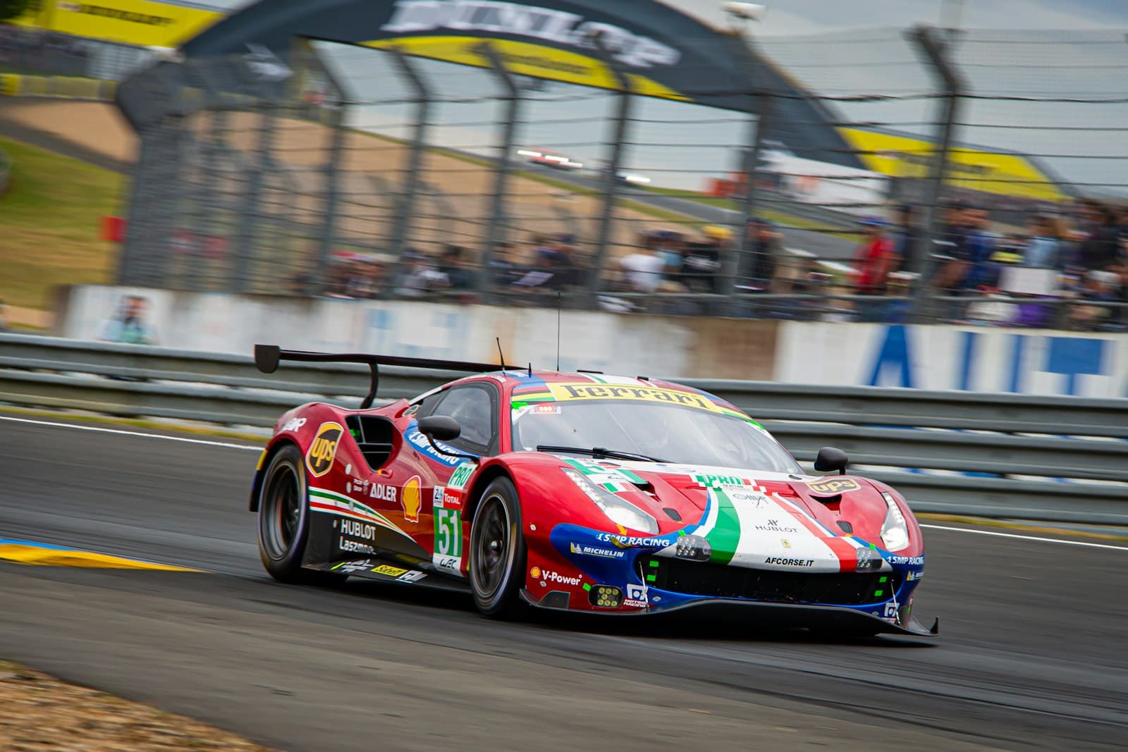 Le Mans — red and white ferrari f 1 on road