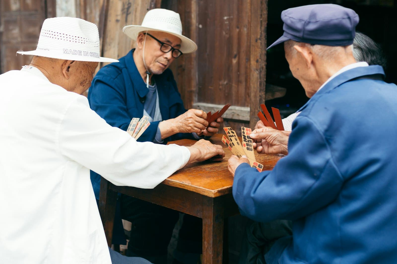 Leshan — a group of elderly people playing a game of cards