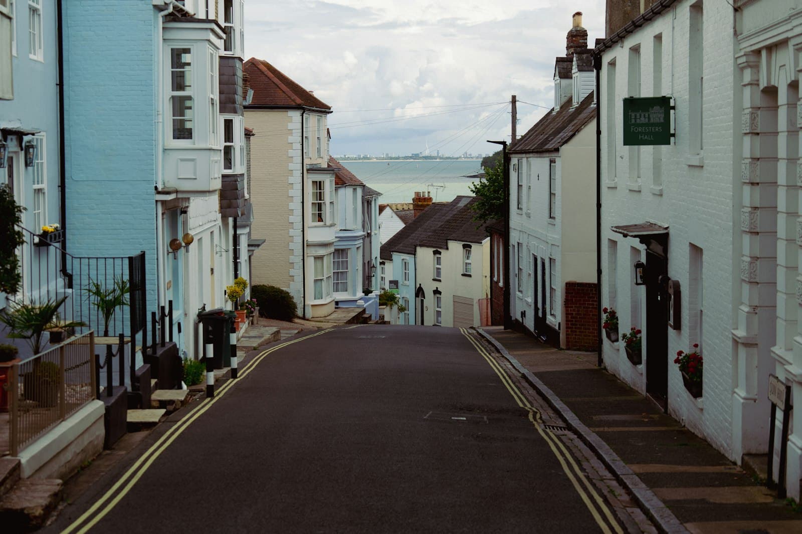 Lewes — a narrow street lined with white buildings next to a body of water