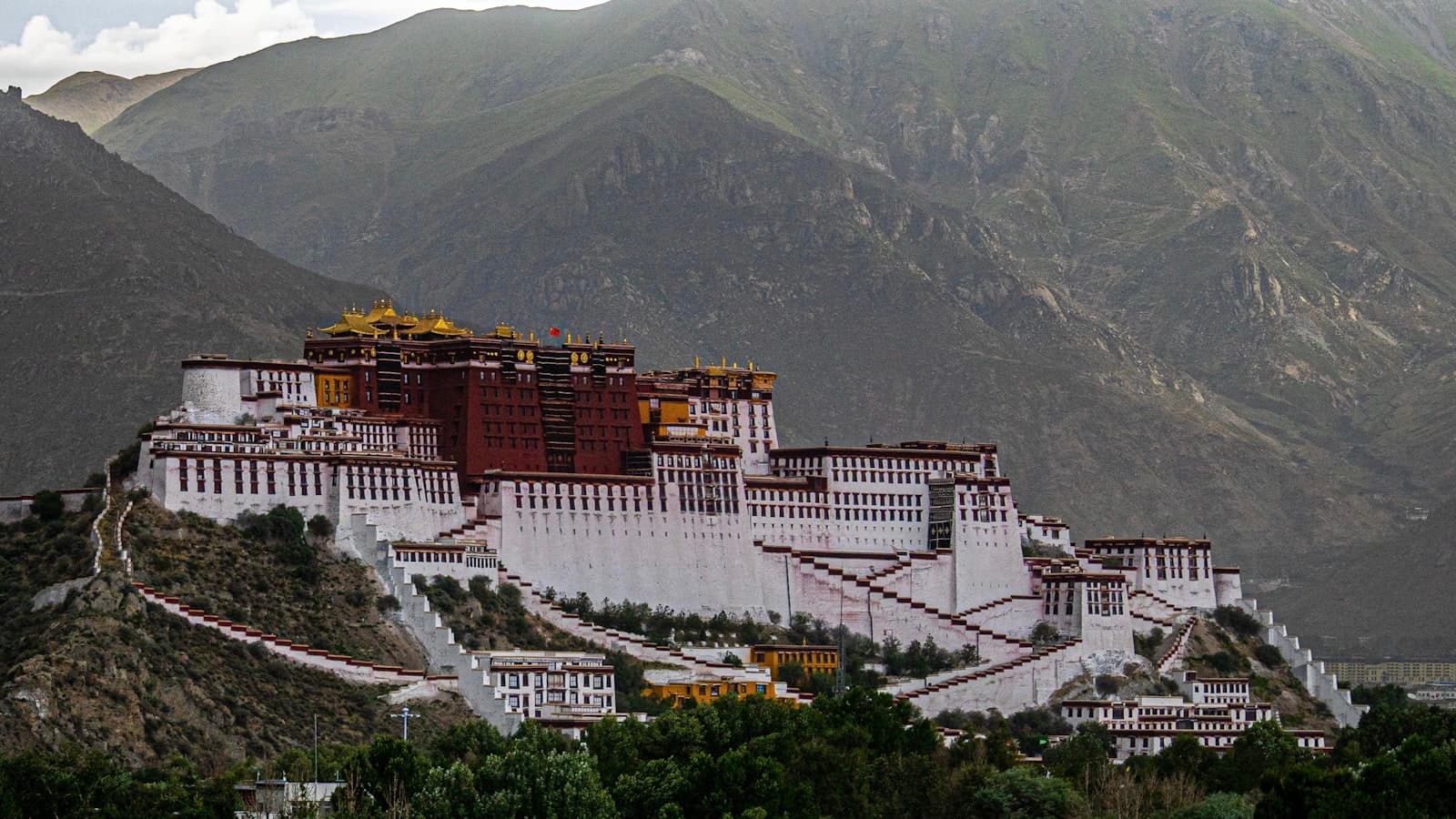 Lhasa — white and brown concrete building near mountain during daytime
