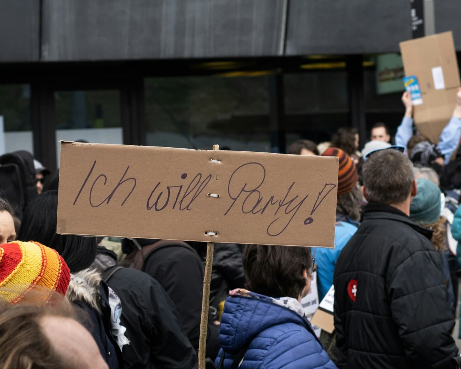 Liestal — people standing and holding brown wooden board during daytime