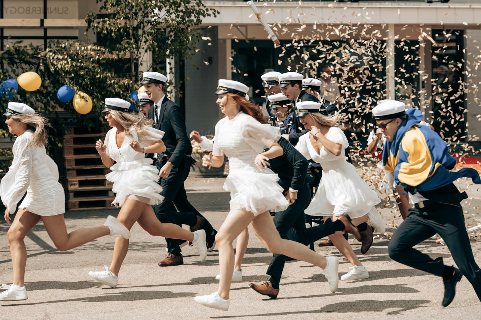 Ljungby — Graduates in white dresses run, celebrating their milestone