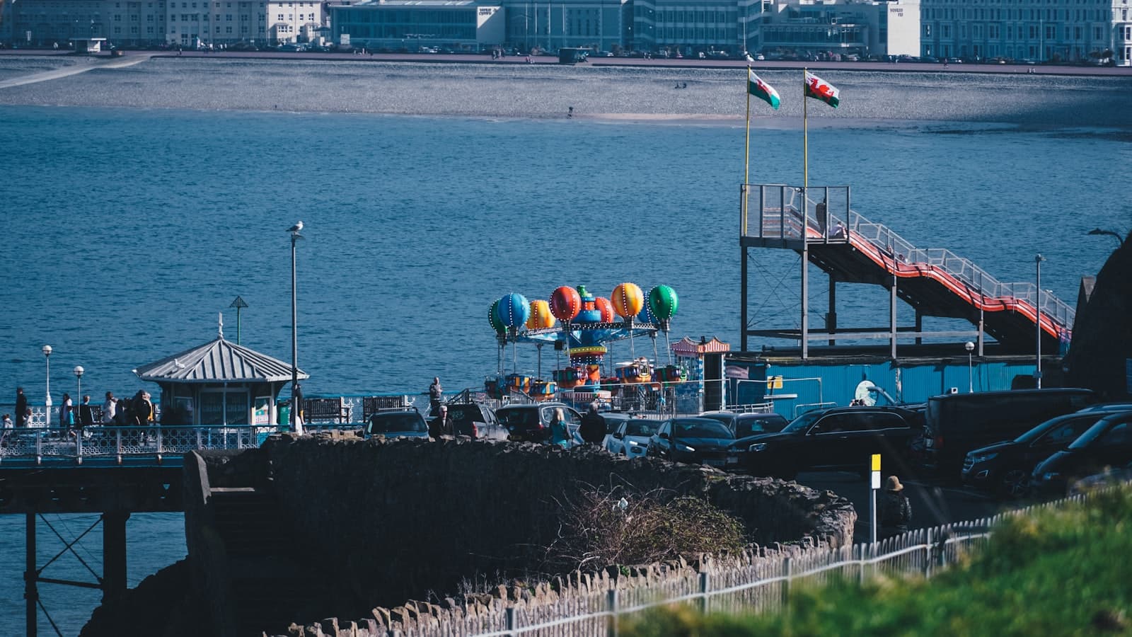 Llandudno — a body of water with balloons and cars by it