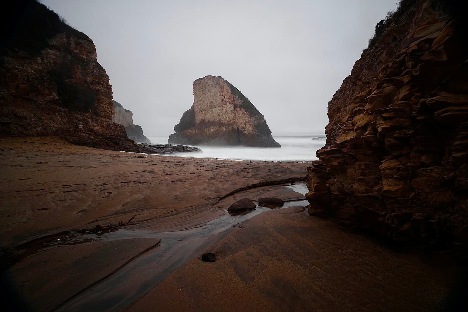 Long Beach — brown rock formation near body of water during daytime
