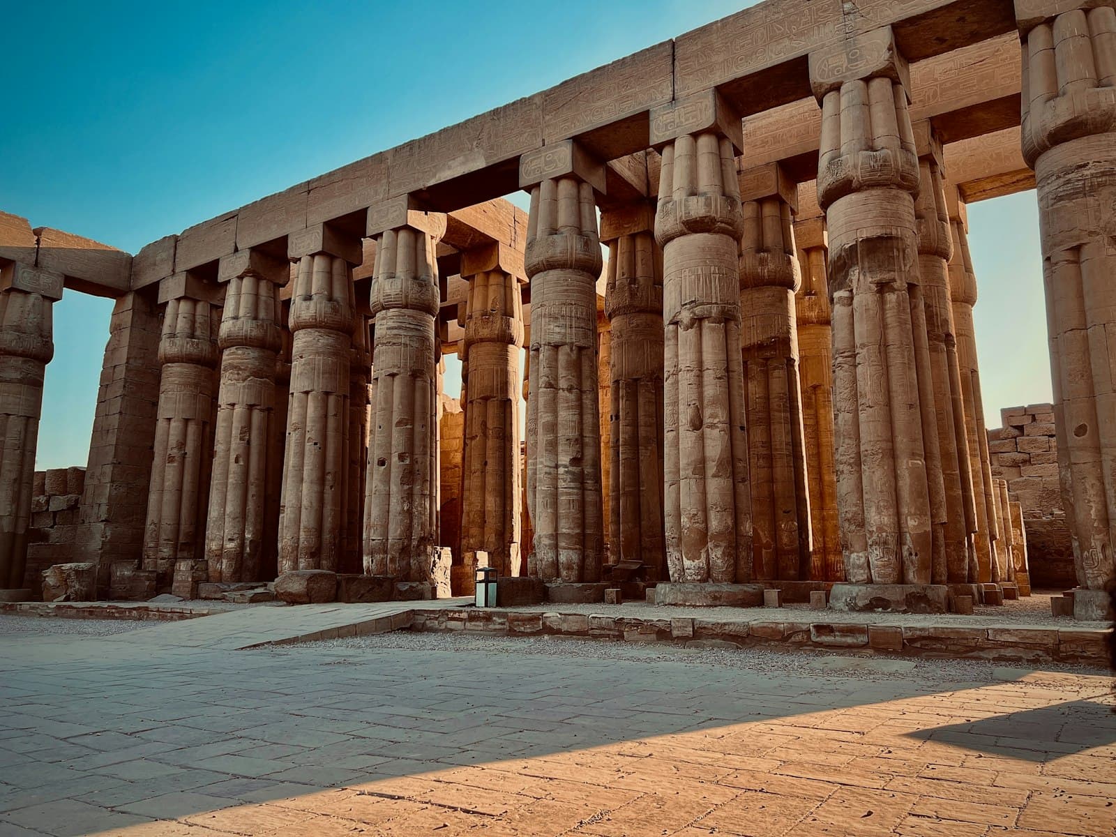 Luxor — a person standing in front of a large stone structure