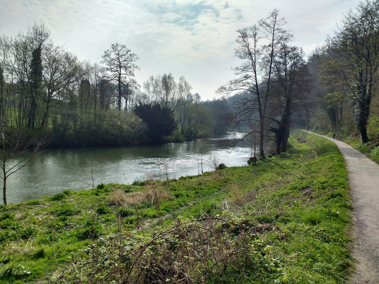 Ludlow — A man riding a bike down a dirt road next to a river