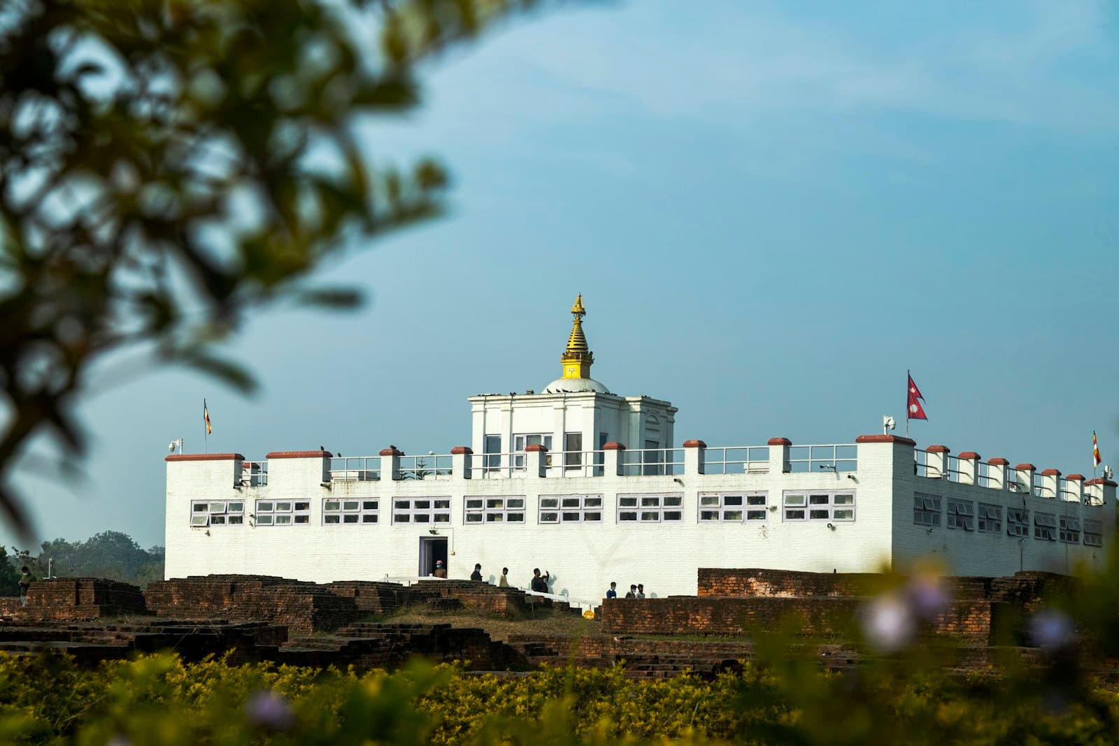 Lumbini — white concrete building under blue sky during daytime
